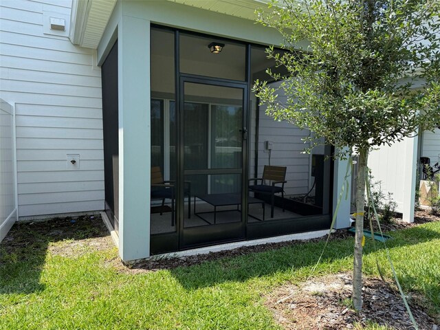 1900 Erudite Way, Winter Park, FL 32792 - rear view of property with a sunroom and a yard