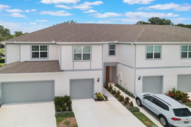 1900 Erudite Way, Winter Park, FL 32792 - view of property featuring an attached garage, a shingled roof, and driveway