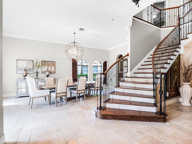 1417 Terralago Pl, Oviedo, FL 32765 - stairway with stone tile floors, a chandelier, ornamental molding, baseboards, and a towering ceiling