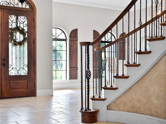 1417 Terralago Pl, Oviedo, FL 32765 - foyer featuring baseboards, stone tile flooring, stairs, and crown molding