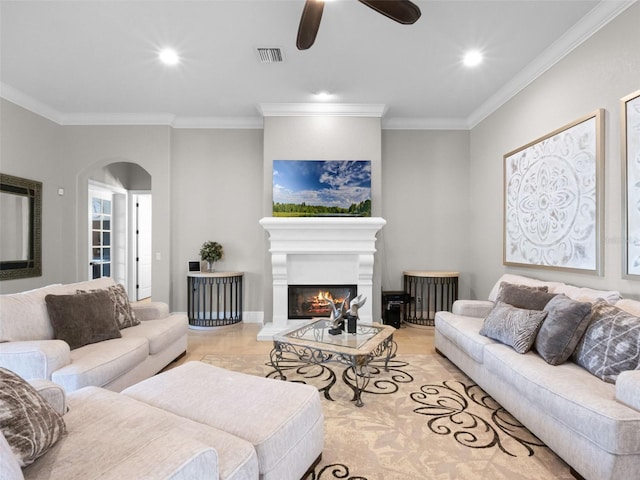 1417 Terralago Pl, Oviedo, FL 32765 - living area with arched walkways, crown molding, a ceiling fan, a lit fireplace, and recessed lighting