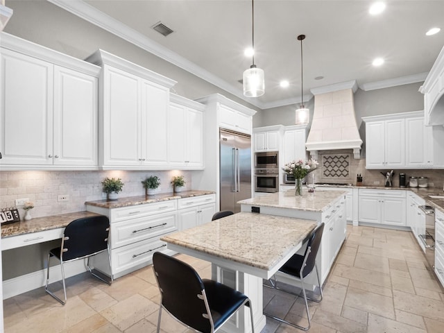 1417 Terralago Pl, Oviedo, FL 32765 - kitchen with built in appliances, custom exhaust hood, stone tile floors, recessed lighting, and crown molding