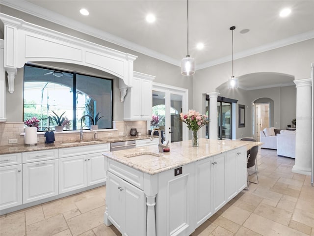 1417 Terralago Pl, Oviedo, FL 32765 - kitchen with stone tile flooring, a sink, arched walkways, decorative backsplash, and recessed lighting