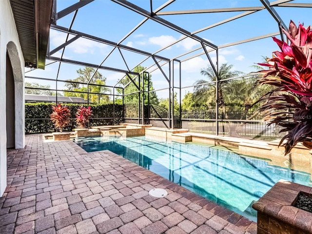 1417 Terralago Pl, Oviedo, FL 32765 - view of pool featuring a patio, a pool with connected hot tub, glass enclosure, and a fenced backyard