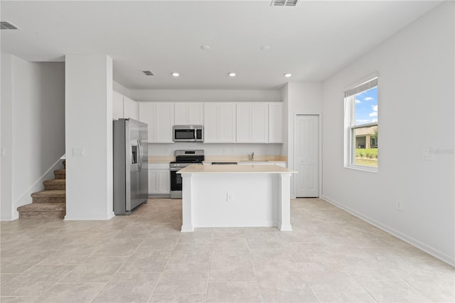2716 Pierr St, Davenport, FL 33837 - kitchen featuring stainless steel appliances, recessed lighting, light countertops, a sink, and white cabinets
