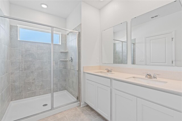 2716 Pierr St, Davenport, FL 33837 - bathroom with a shower stall, double vanity, and tile patterned floors