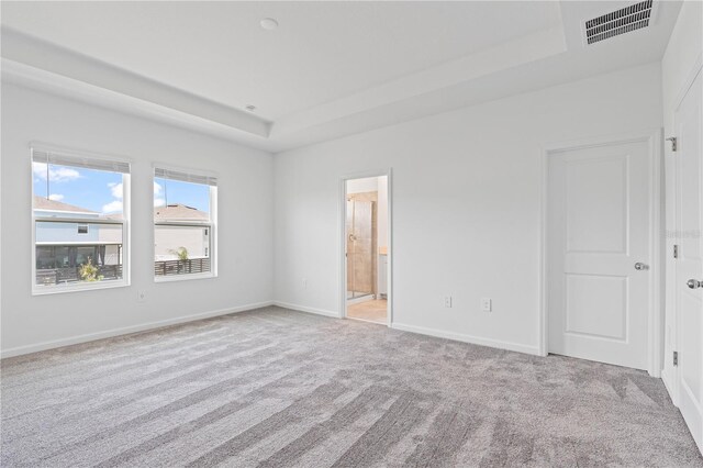 2716 Pierr St, Davenport, FL 33837 - carpeted spare room featuring a tray ceiling and baseboards