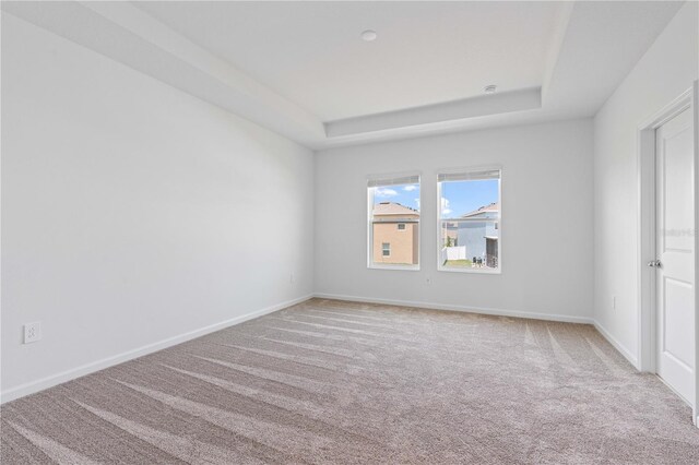 2716 Pierr St, Davenport, FL 33837 - carpeted spare room featuring a raised ceiling and baseboards