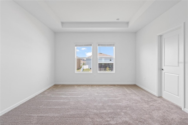2716 Pierr St, Davenport, FL 33837 - empty room featuring a tray ceiling, carpet floors, and baseboards