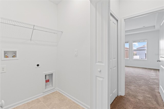 2716 Pierr St, Davenport, FL 33837 - laundry room with hookup for an electric dryer, hookup for a washing machine, baseboards, and light colored carpet