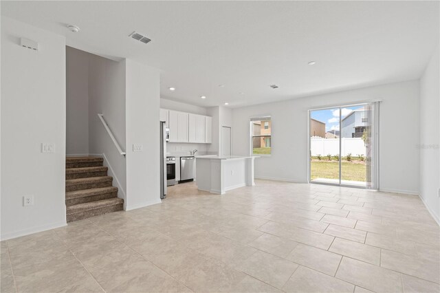 2716 Pierr St, Davenport, FL 33837 - unfurnished living room featuring stairs, recessed lighting, light tile patterned floors, and baseboards