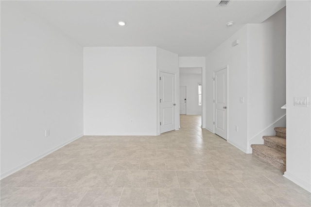 2716 Pierr St, Davenport, FL 33837 - empty room featuring stairs, baseboards, a smoke detector, and light tile patterned flooring