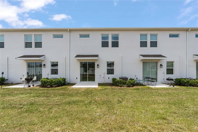 2716 Pierr St, Davenport, FL 33837 - rear view of property with stucco siding, a patio area, and a yard