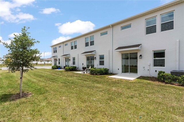 2716 Pierr St, Davenport, FL 33837 - rear view of property featuring stucco siding, a yard, and central air condition unit