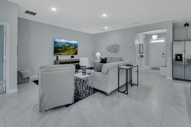 1580 Delphi Way, New Smyrna Beach, FL 32168 - living room with recessed lighting, baseboards, and light tile patterned floors