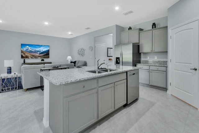 1580 Delphi Way, New Smyrna Beach, FL 32168 - kitchen featuring stainless steel appliances, a sink, gray cabinetry, open floor plan, and a kitchen island with sink