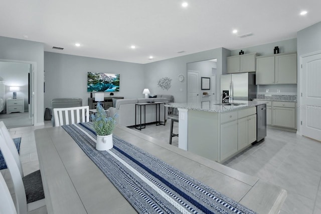 1580 Delphi Way, New Smyrna Beach, FL 32168 - kitchen with appliances with stainless steel finishes, a sink, recessed lighting, light stone countertops, and open floor plan
