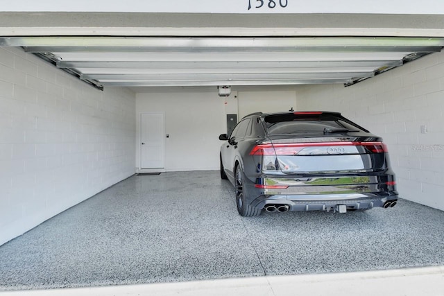 1580 Delphi Way, New Smyrna Beach, FL 32168 - garage with a garage door opener, concrete block wall, and electric panel