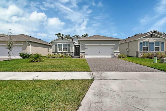 1580 Delphi Way, New Smyrna Beach, FL 32168 - single story home featuring driveway, stucco siding, an attached garage, stone siding, and a front lawn