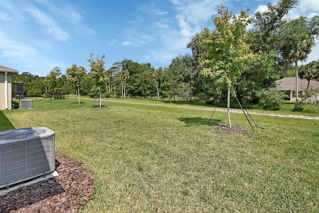 1580 Delphi Way, New Smyrna Beach, FL 32168 - view of grassy yard featuring central air condition unit and view of scattered trees