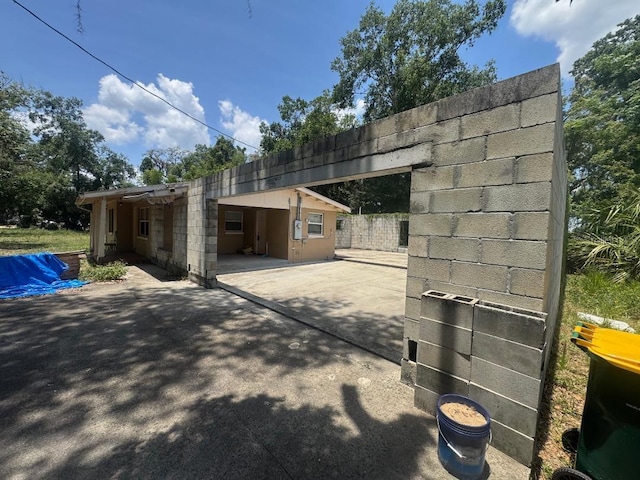 625 E Jackson Ave, Mount Dora, FL 32757 - view of home's exterior with an attached carport, a patio area, and driveway
