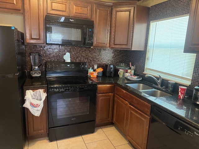 625 E Jackson Ave, Mount Dora, FL 32757 - kitchen featuring black appliances, a sink, light tile patterned flooring, decorative backsplash, and brown cabinetry