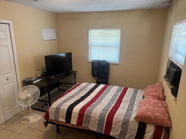 625 E Jackson Ave, Mount Dora, FL 32757 - tiled bedroom with a textured ceiling and cooling unit