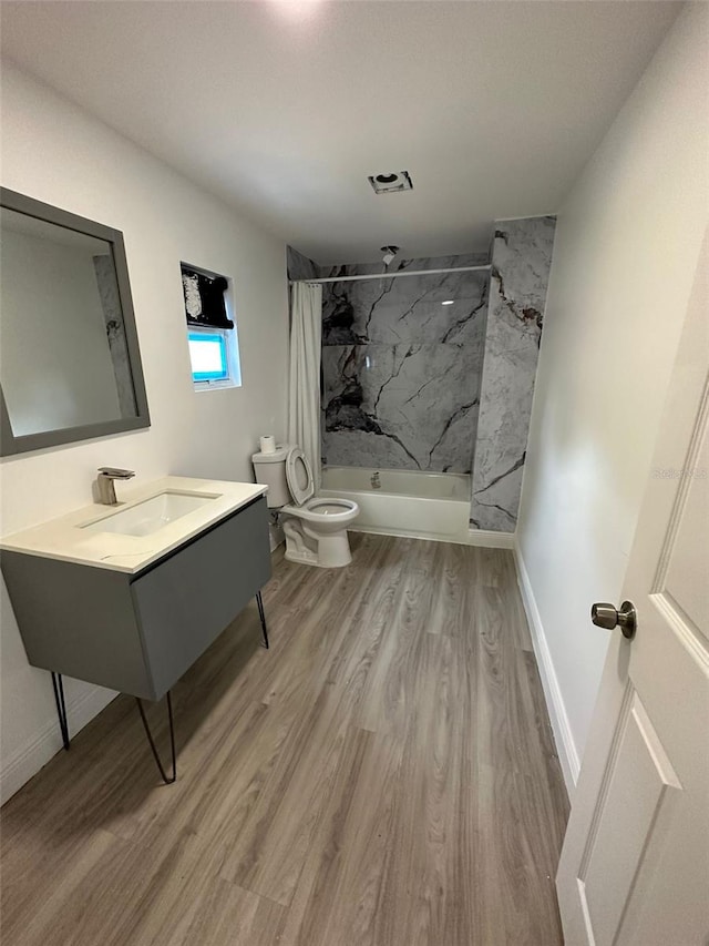 8612 N Alaska St, Tampa, FL 33604 - full bath with toilet, wood finished floors, a combined bath / shower with marble appearance, baseboards, and vanity