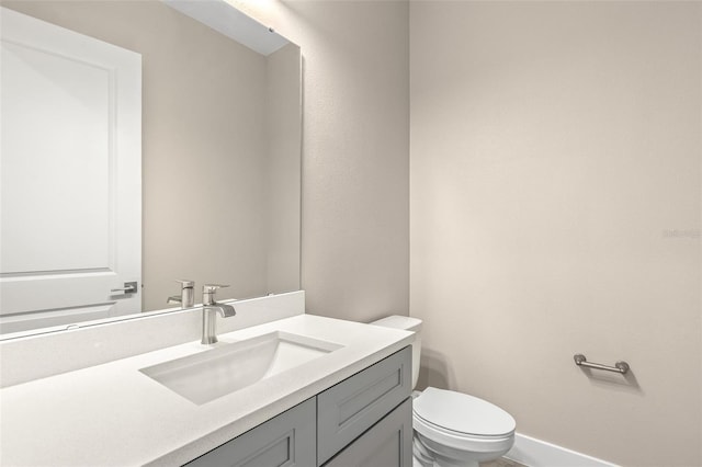 1262 Champions Dr, Daytona Beach, FL 32124 - half bathroom with vanity, toilet, and baseboards
