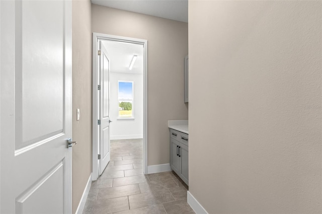 1262 Champions Dr, Daytona Beach, FL 32124 - hallway featuring light tile patterned floors and baseboards