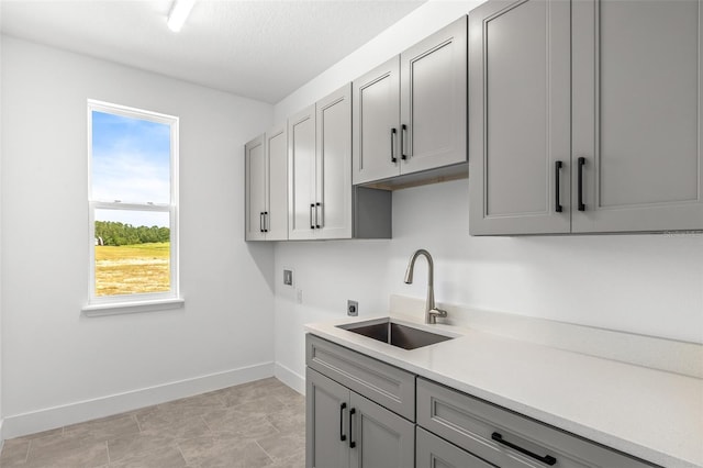 1262 Champions Dr, Daytona Beach, FL 32124 - laundry room with hookup for an electric dryer, hookup for a washing machine, cabinet space, and baseboards