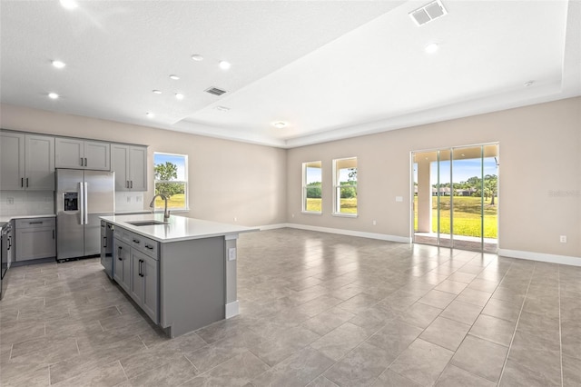 1262 Champions Dr, Daytona Beach, FL 32124 - kitchen featuring stainless steel refrigerator with ice dispenser, gray cabinets, a sink, recessed lighting, and baseboards