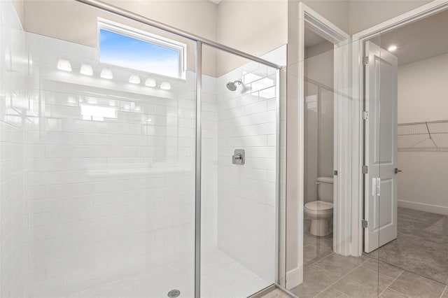 1262 Champions Dr, Daytona Beach, FL 32124 - bathroom featuring a stall shower, toilet, a walk in closet, and tile patterned flooring