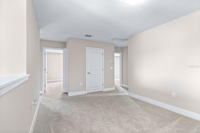 1262 Champions Dr, Daytona Beach, FL 32124 - unfurnished room with carpet, baseboards, and a textured ceiling
