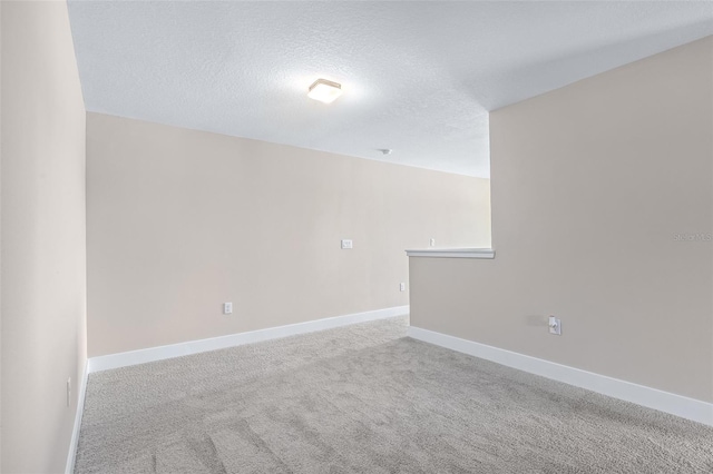 1262 Champions Dr, Daytona Beach, FL 32124 - carpeted spare room with a textured ceiling and baseboards