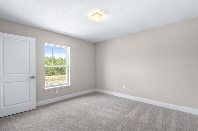 1262 Champions Dr, Daytona Beach, FL 32124 - carpeted empty room with baseboards and a textured ceiling