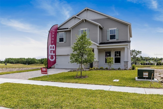 1262 Champions Dr, Daytona Beach, FL 32124 - craftsman-style house with decorative driveway, a front lawn, and an attached garage