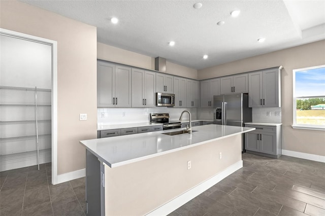 1262 Champions Dr, Daytona Beach, FL 32124 - kitchen with stainless steel appliances, gray cabinetry, a sink, baseboards, and recessed lighting