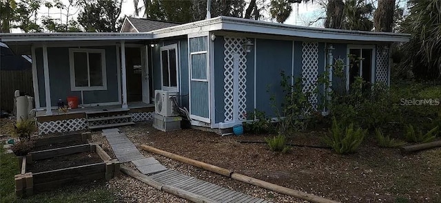 6505 Oelsner St, New Port Richey, FL 34652 - view of side of home with a cooling unit and covered porch