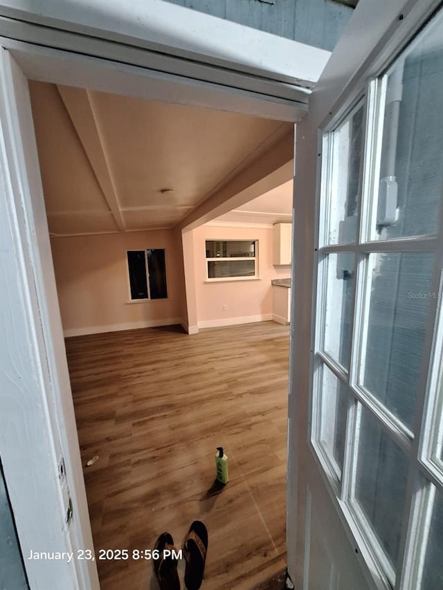 6505 Oelsner St, New Port Richey, FL 34652 - unfurnished living room with baseboards and wood finished floors
