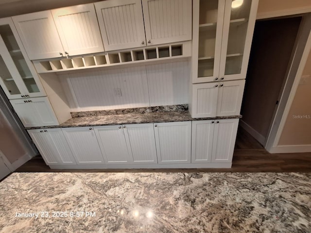 6505 Oelsner St, New Port Richey, FL 34652 - mudroom featuring baseboards and dark wood-type flooring