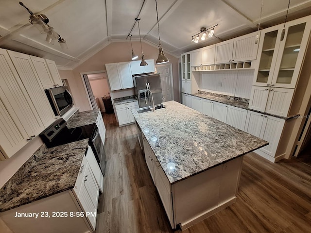 6505 Oelsner St, New Port Richey, FL 34652 - kitchen with dark wood-type flooring, stainless steel appliances, an island with sink, a sink, and glass insert cabinets