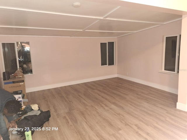 6505 Oelsner St, New Port Richey, FL 34652 - unfurnished living room featuring wood finished floors and baseboards