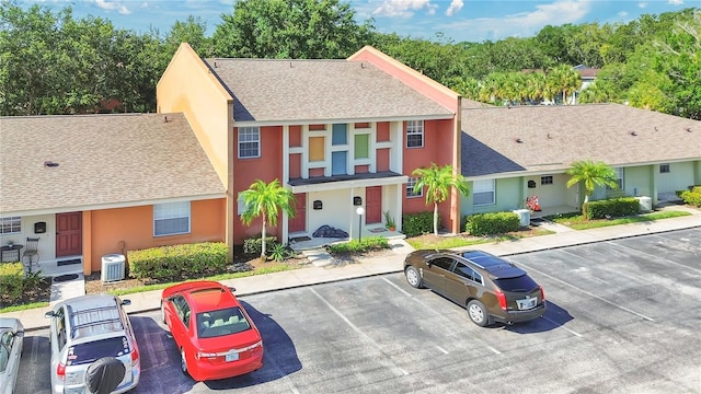 4952 Tangerine Ave Unit 4952, Winter Park, FL 32792 - multi unit property with uncovered parking, central air condition unit, a shingled roof, and stucco siding