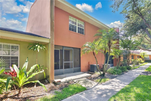 4952 Tangerine Ave Unit 4952, Winter Park, FL 32792 - back of house featuring central air condition unit and stucco siding