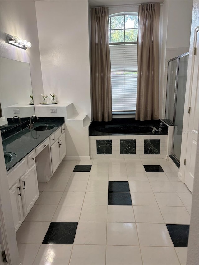 1445 Valley Pine Cir, Apopka, FL 32712 - bathroom with double vanity, a garden tub, tile patterned floors, a shower stall, and baseboards