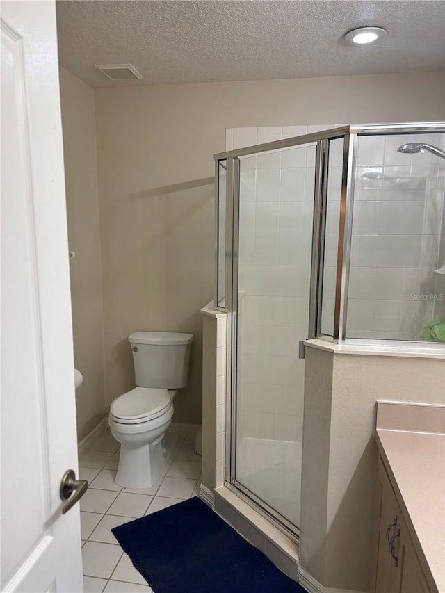 1445 Valley Pine Cir, Apopka, FL 32712 - bathroom with a textured ceiling, toilet, tile patterned flooring, a stall shower, and vanity