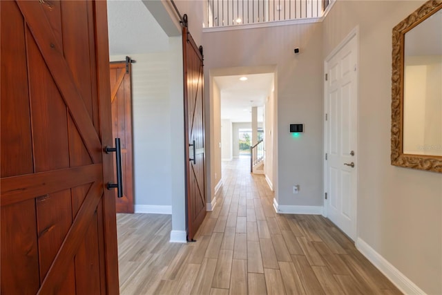 4861 Antrim Dr, Sarasota, FL 34240 - hall with a barn door and light wood-style flooring