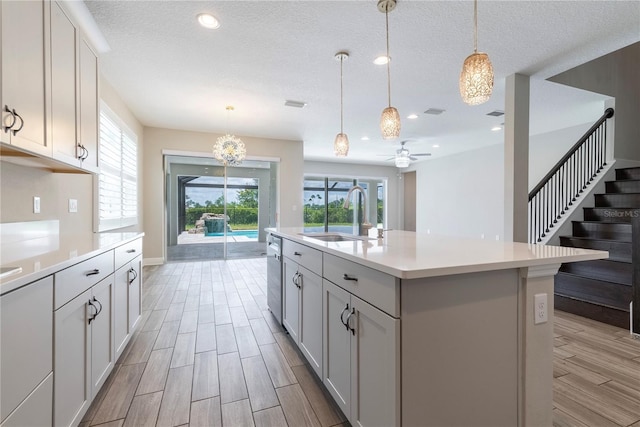 4861 Antrim Dr, Sarasota, FL 34240 - kitchen with plenty of natural light, light countertops, stainless steel dishwasher, light wood-type flooring, and recessed lighting