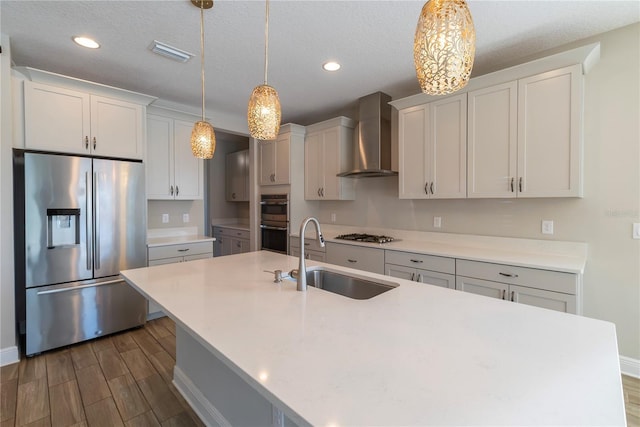 4861 Antrim Dr, Sarasota, FL 34240 - kitchen featuring stainless steel appliances, wall chimney exhaust hood, an island with sink, dark wood-style flooring, and recessed lighting